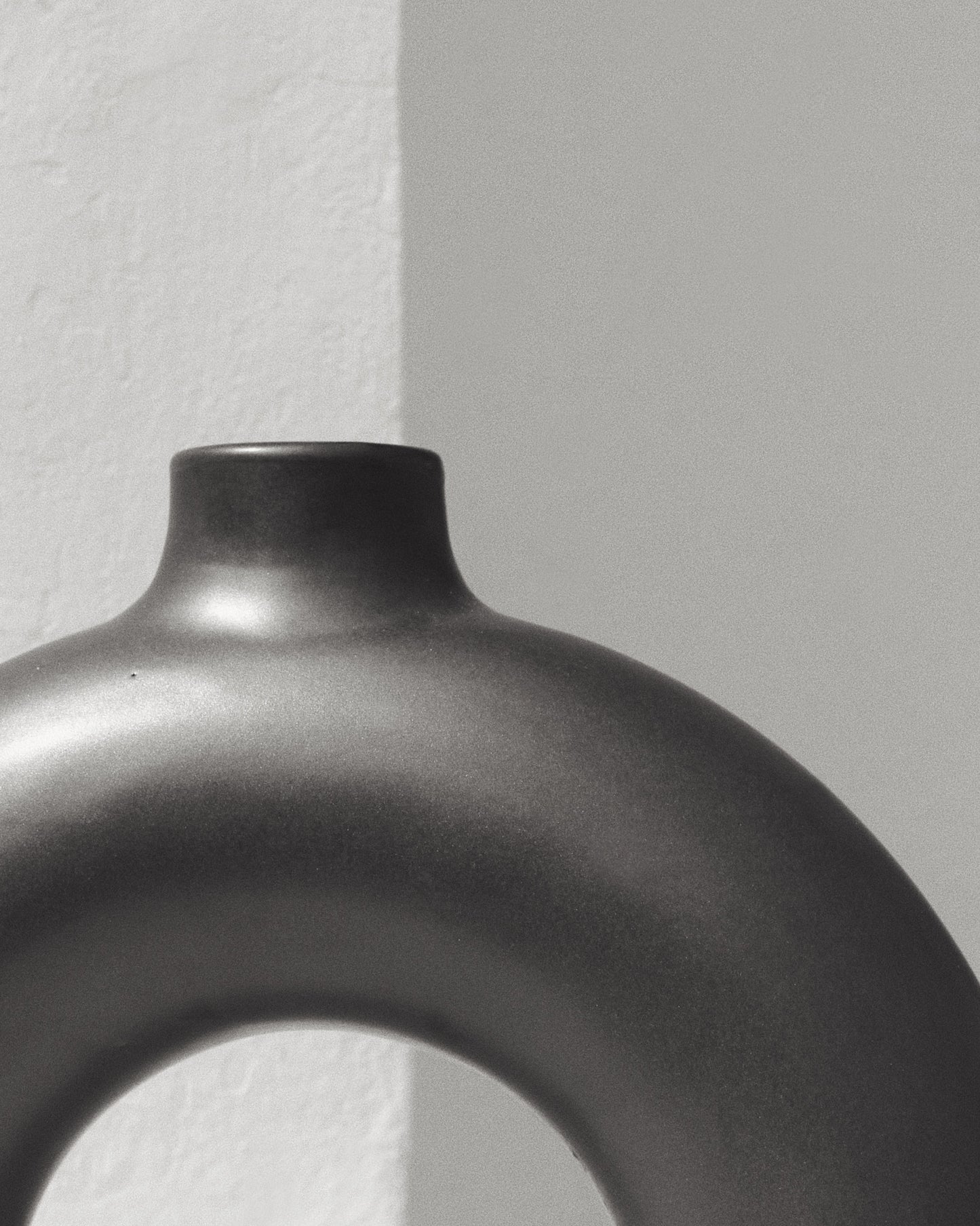 donut shaped vase which is half a circle