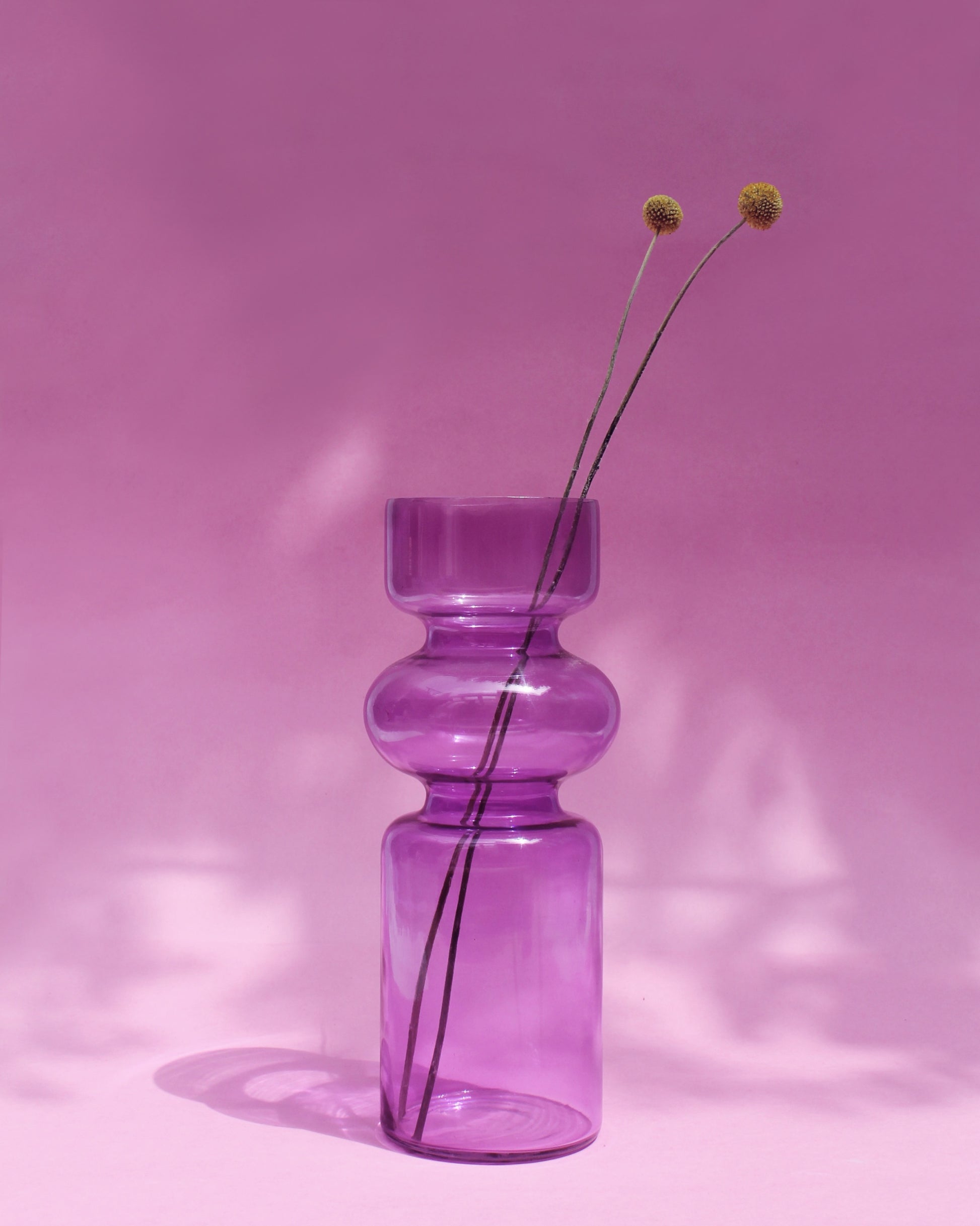 Modern glass vase with yellow flowers