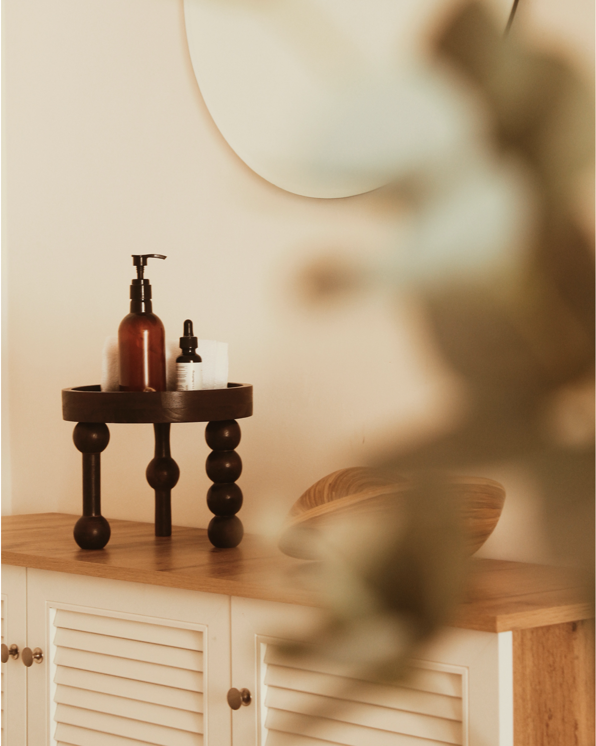 Wooden stool with beauty creams on the top