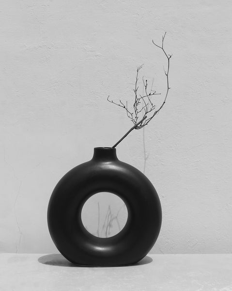 Black Donut vase with dried twigs