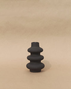Matte black sculptural vase with grainy texture