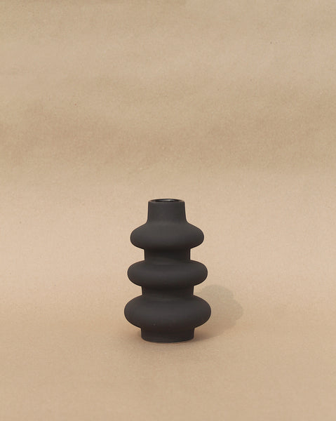 Matte black sculptural vase with grainy texture