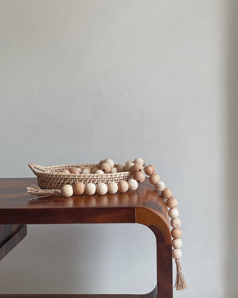 Wooden beads lying in a jute tray