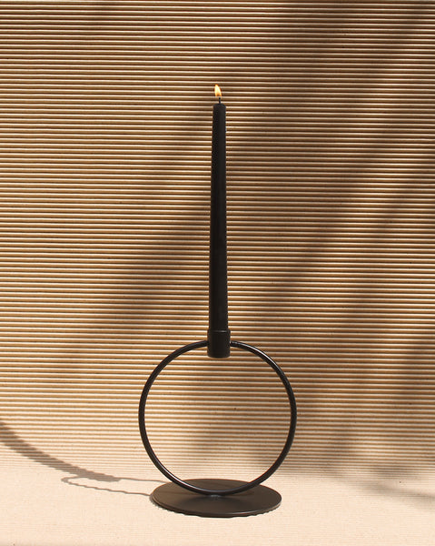 Candle stand with black taper candle