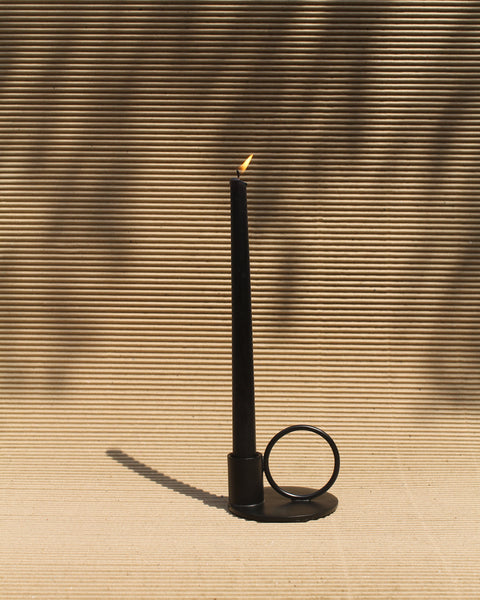 Matte black candles in a matte black candle stand
