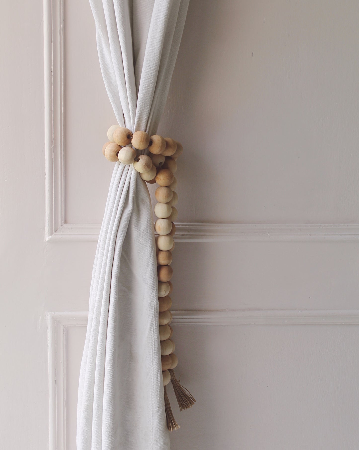A bohemian style wooden beads tied to a curtain